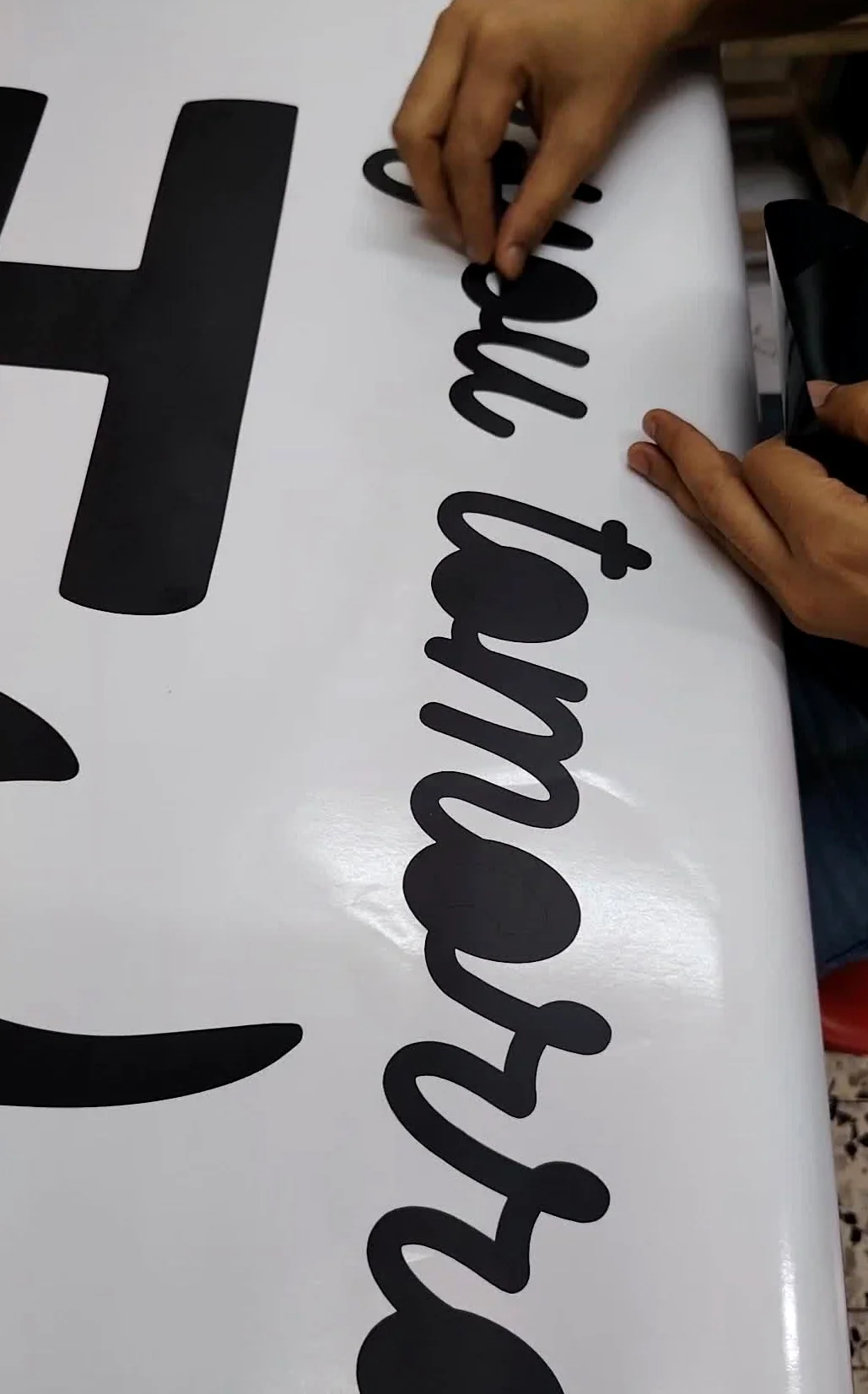 Vinyl lettering application in progress